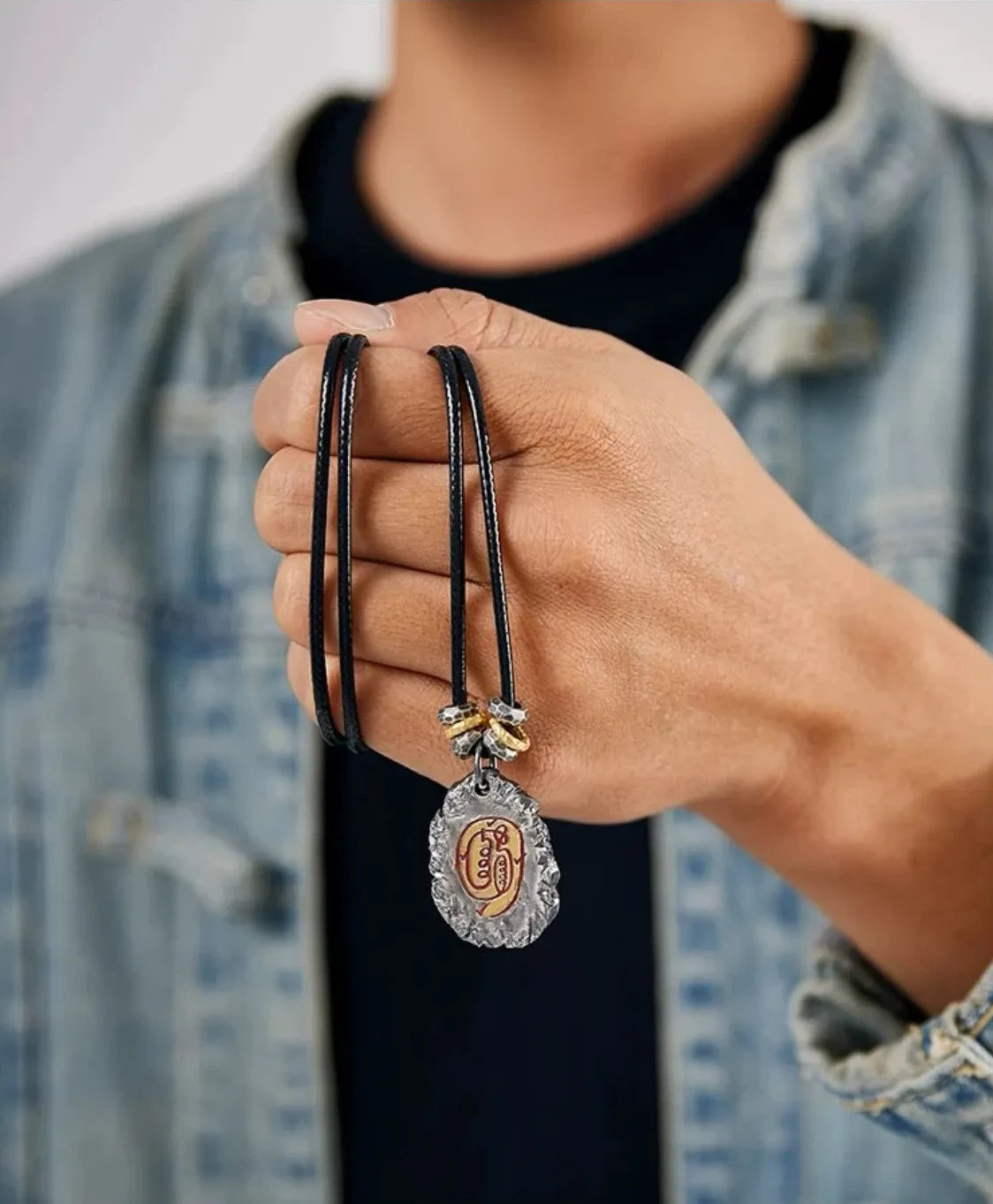 Lifestyle shot of a model wearing the Incantation necklace, highlighting the vintage silver and gold contrast