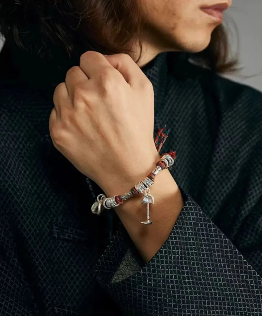 Artistic shot showing the contrast between the playful wealth charms and the traditional Sashiko-style fabric of the outfit