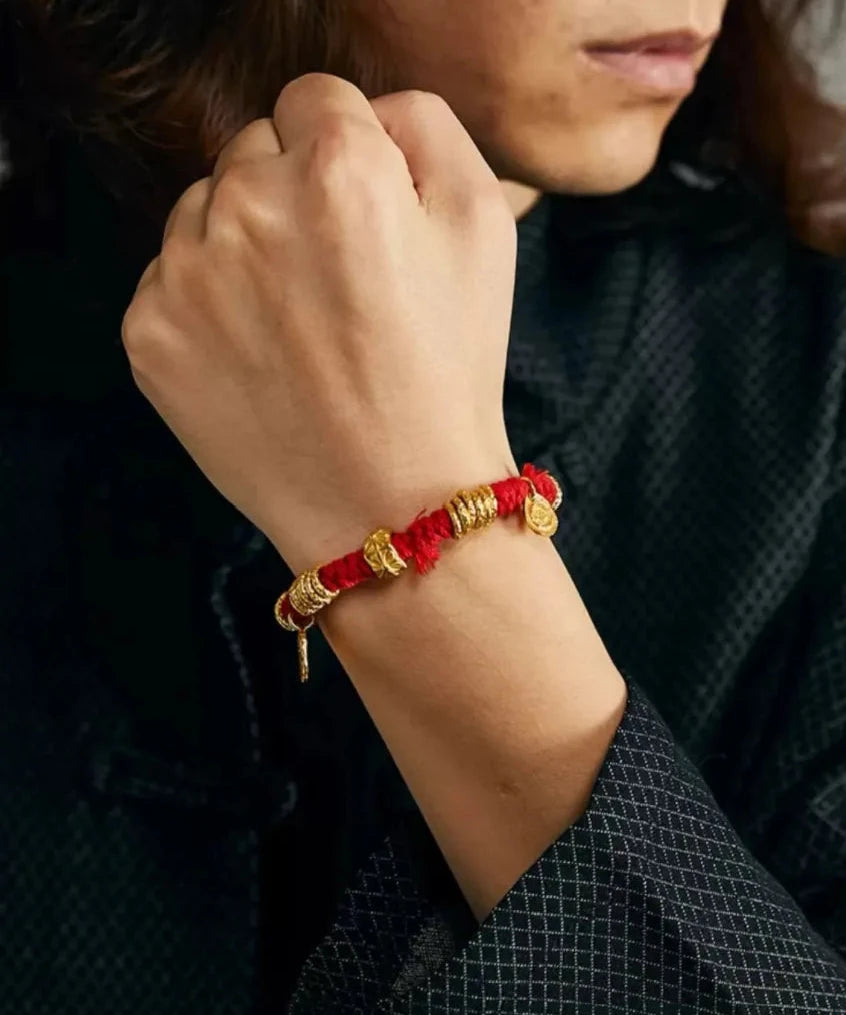 A powerful fist pose showcasing the bracelet as a symbol of strength, protection, and good fortune