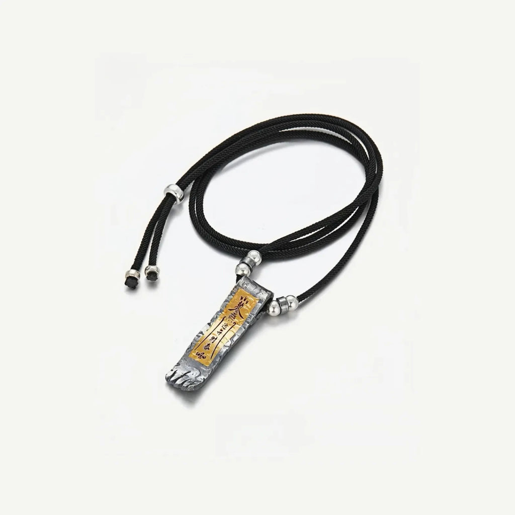 Flat lay of men's spiritual necklace with adjustable black cord and silver beads