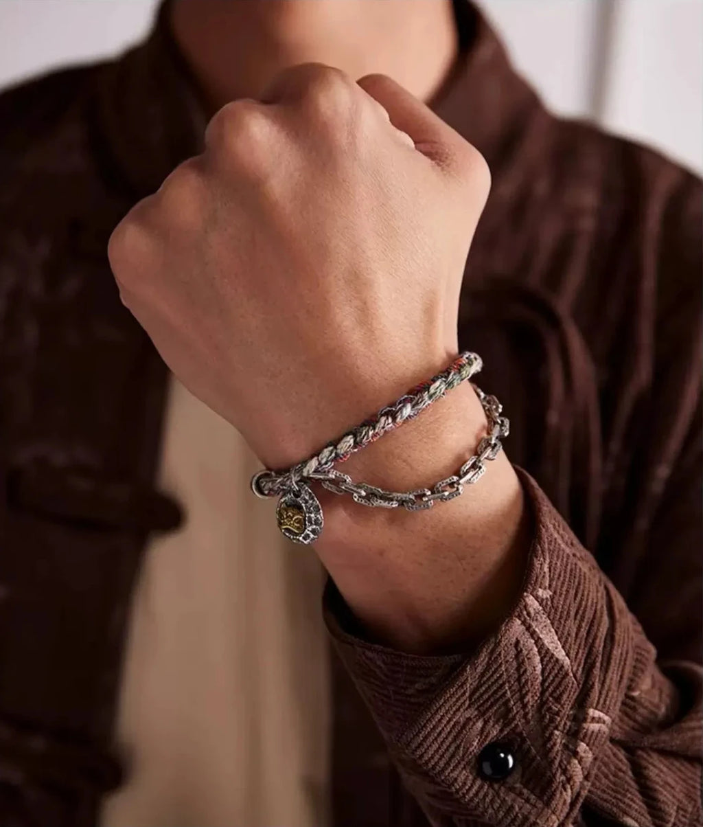 Lifestyle shot of a man wearing a brown corduroy shirt, showcasing the bracelet as a statement piece that blends vintage culture with modern fashion