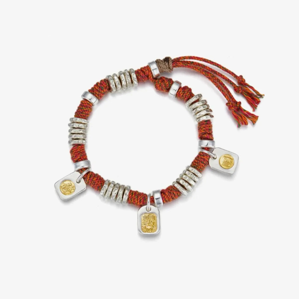 Top-down view highlighting the spacing of the three lucky charms and the industrial silver coils