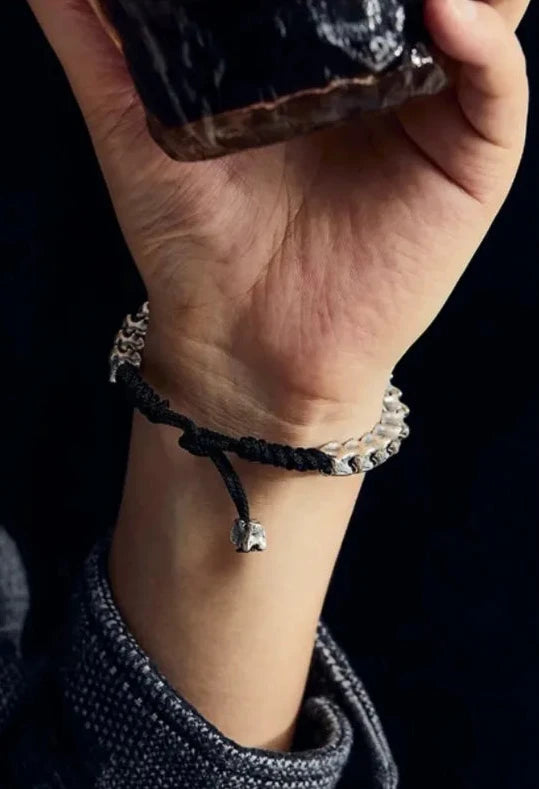 Detailed shot on the hand, emphasizing the oxidized texture of the silver bones against the skin