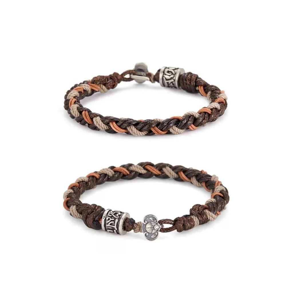 Front view of the Blessing Bracelet, featuring a silver Tibetan mantra bead and a lucky bat charm on a mixed-material braid