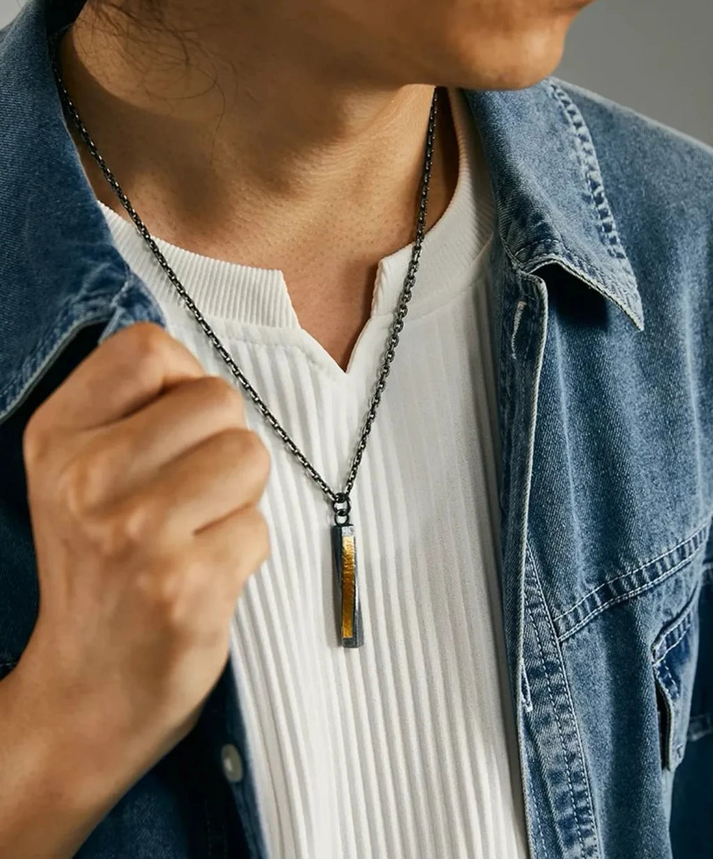 Front view of the model wearing the necklace, illustrating the pendant's drop length and modern minimalist style