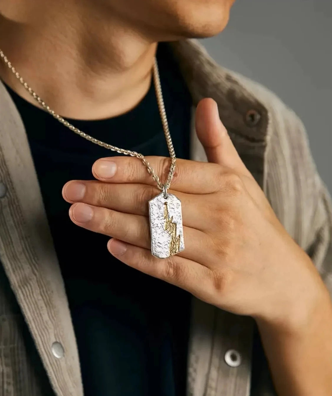 Side view of a model wearing the silver Thunderbolt necklace
