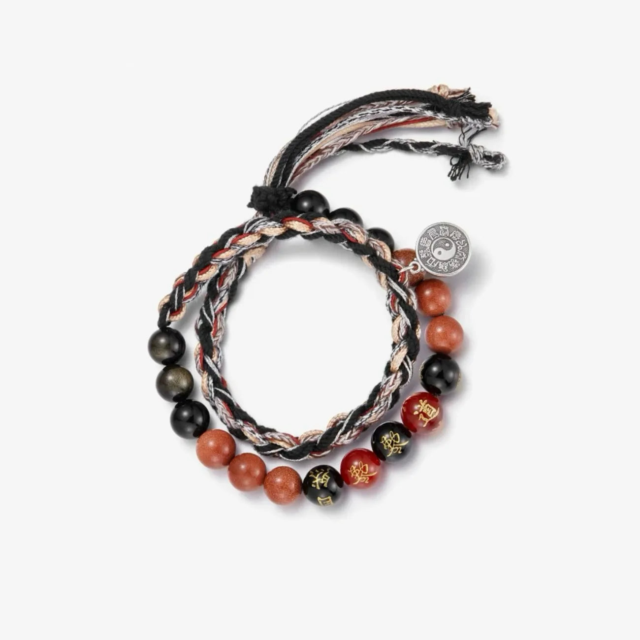 Top-down macro shot capturing the golden sparkles in the red stones and the gold calligraphy on the black onyx beads