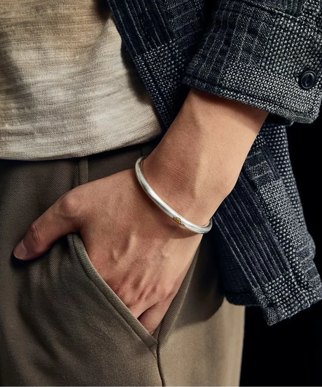 Clear wrist shot showing the gold cloud accent catching the light, adding a focal point to the simple silver band