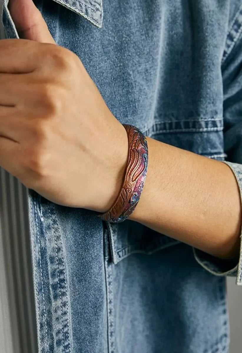 Close-up of the bangle on a male wrist, demonstrating the comfortable fit and the striking contrast of the colorful relief