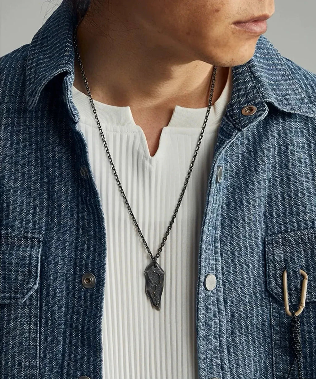 Model wearing the guiding stars necklace with a denim shirt, showcasing the pendant's size and drop length