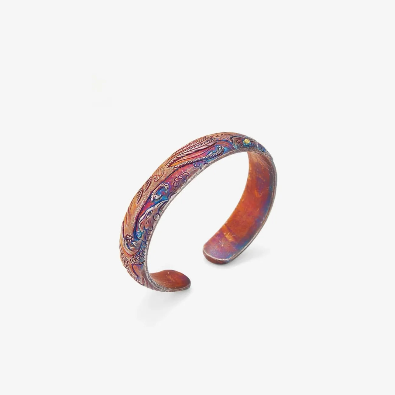 Front view of a handcrafted silver bangle featuring a Phoenix relief with multi-colored oxidized bluing and bronze finish