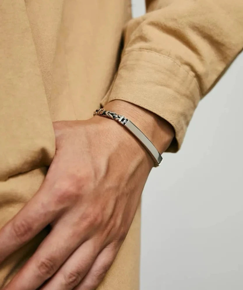 Side angle on the wrist highlighting the thickness of the bar and its industrial "steel beam" aesthetic