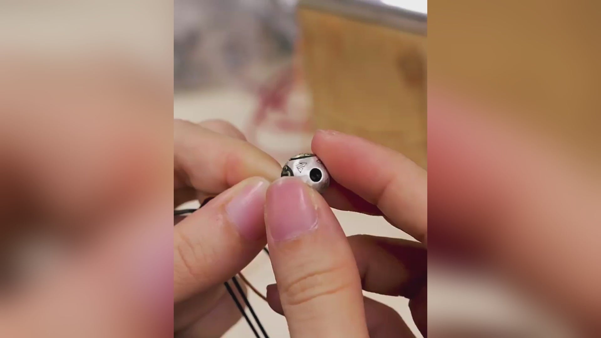 An artisan mindfully strings alternating tiger eye gemstones, polished silver spacer beads, and natural Bodhi seeds onto a cotton cord. The video captures the rhythmic process of knotting, creating a balanced piece that combines earthy energy (stones), spiritual growth (Bodhi), and refined guidance (silver).