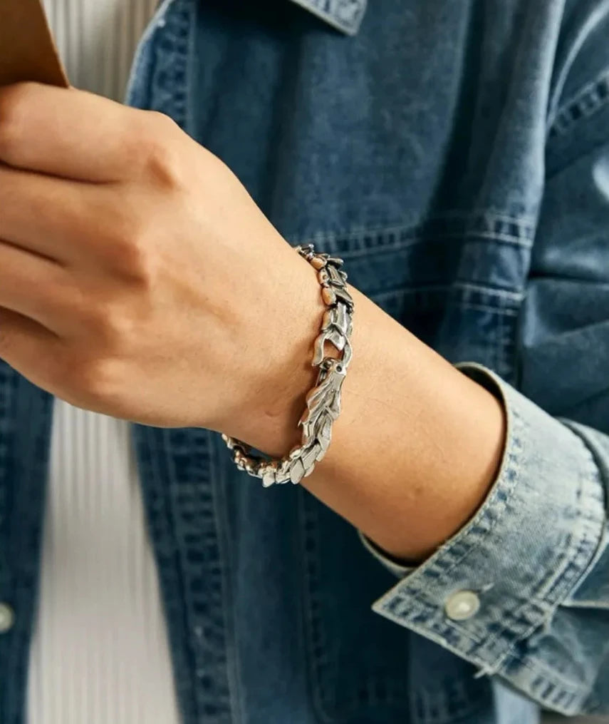 Close-up on the wrist, emphasizing the aggressive armored look and the secure dragon head closure