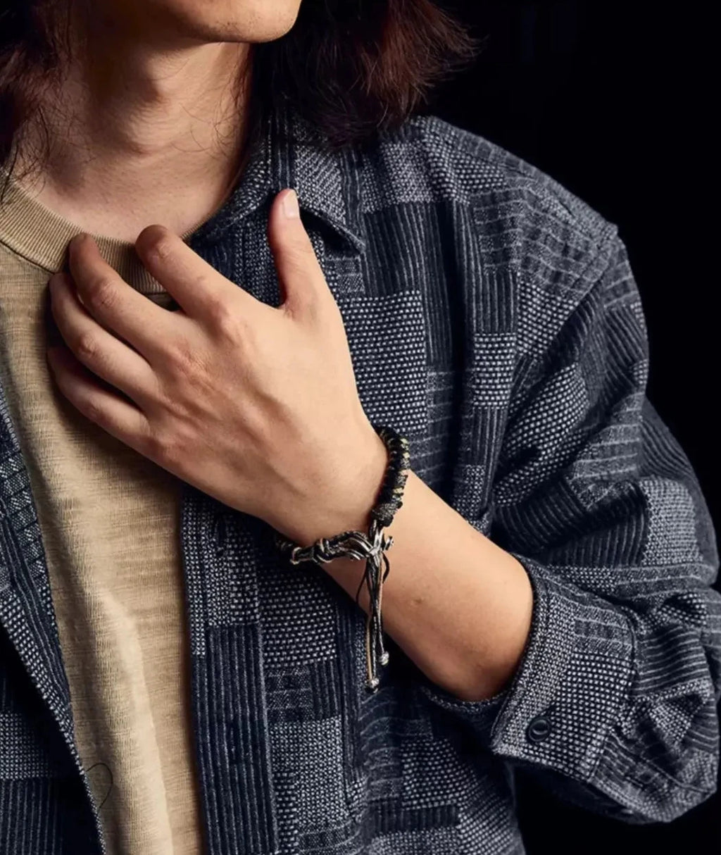 Stylish model wearing the bracelet with a patchwork indigo shirt, demonstrating its appeal for fans of Amekaji and rugged fashion