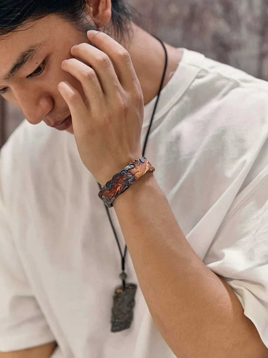 Atmospheric portrait of a model wearing the dragon bangle, emphasizing a cool, retro Asian aesthetic