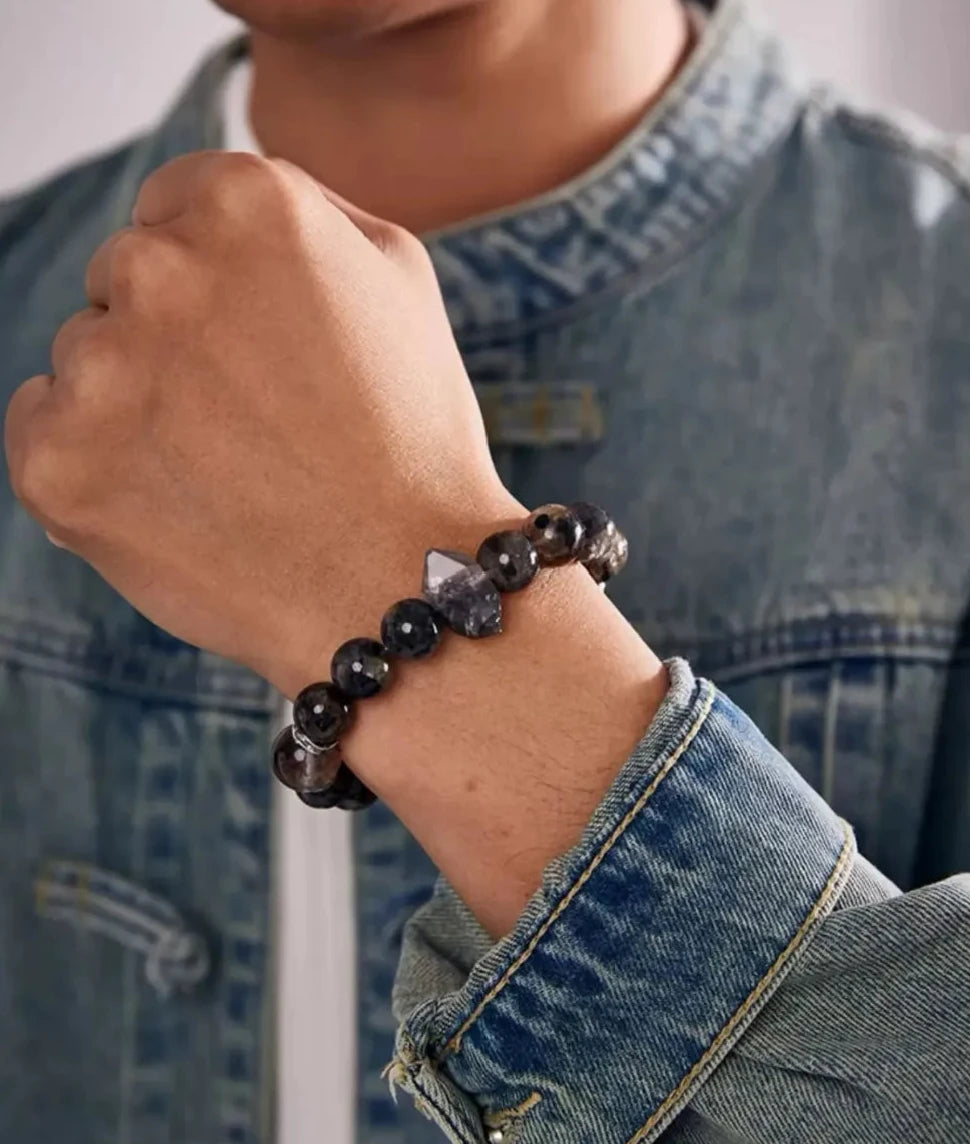 On-wrist view showing the raw crystal point standing out against a denim jacket, creating a rugged, artistic look