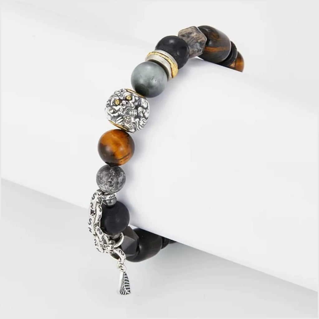 Side view detailing the sterling silver leaf charm and black obsidian protective beads, symbolizing growth and grounding