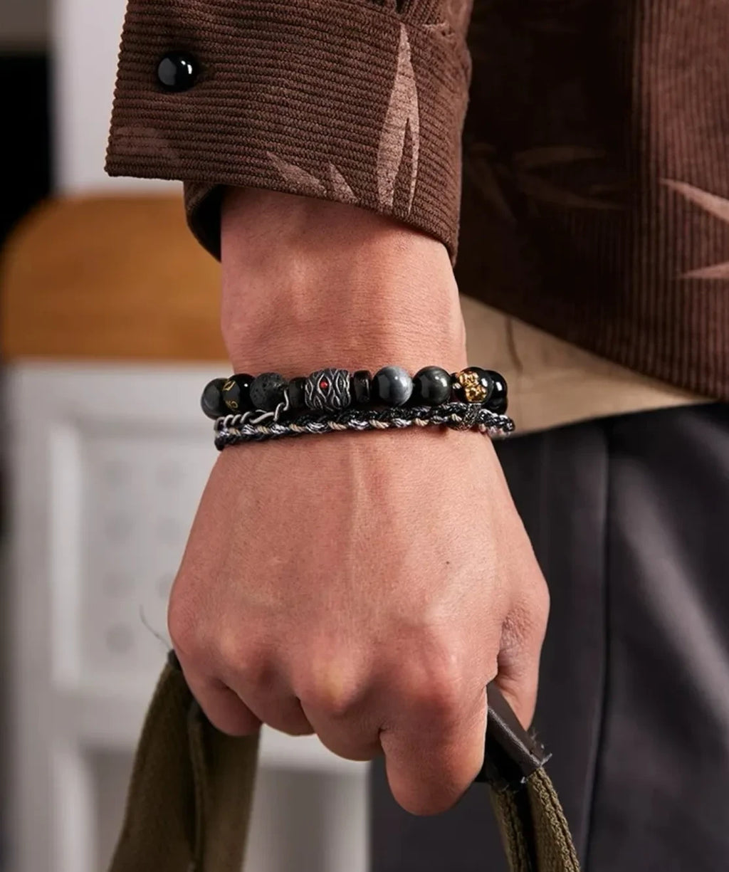 Lifestyle shot of a man wearing the Wukong bracelet, perfectly matching a brown corduroy shirt for a modern urban warrior look