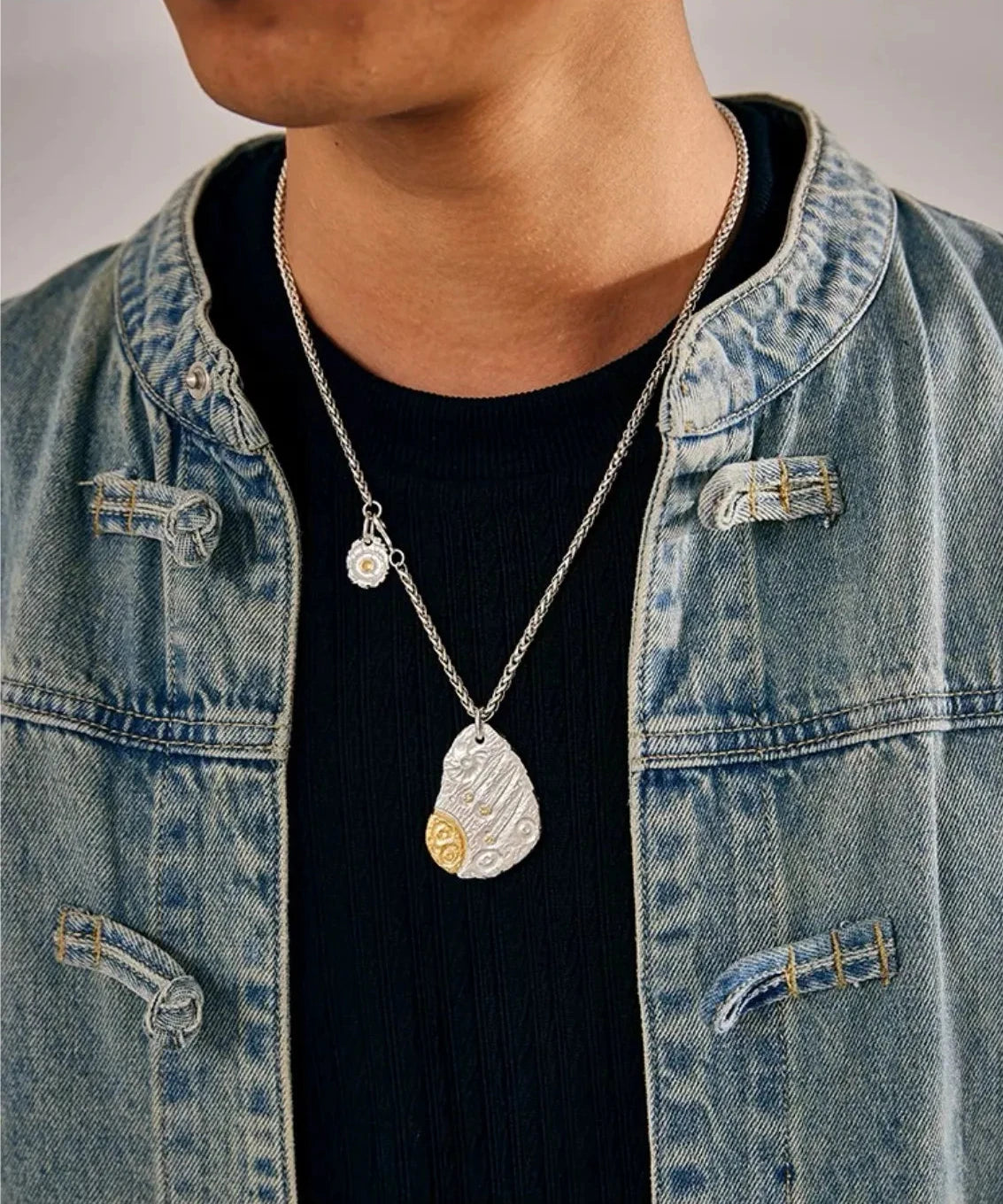 Man wearing the Starway silver necklace styled with a denim jacket and black t-shirt