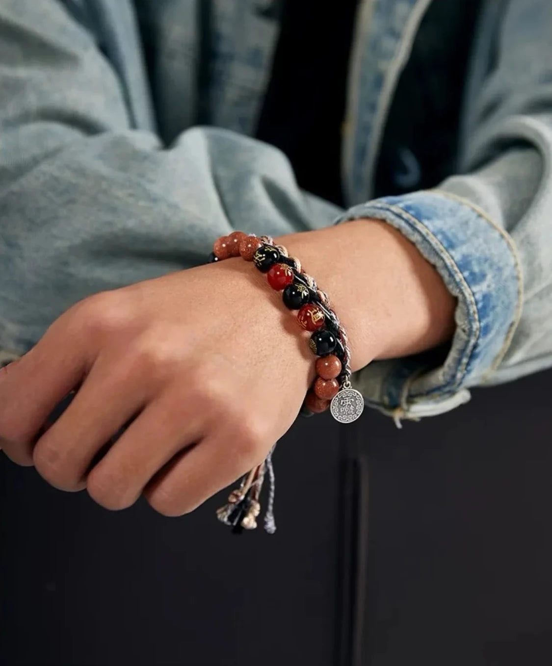 A focused shot of the silver Bagua charm hanging from the wrist, symbolizing balance and protection against negative energy