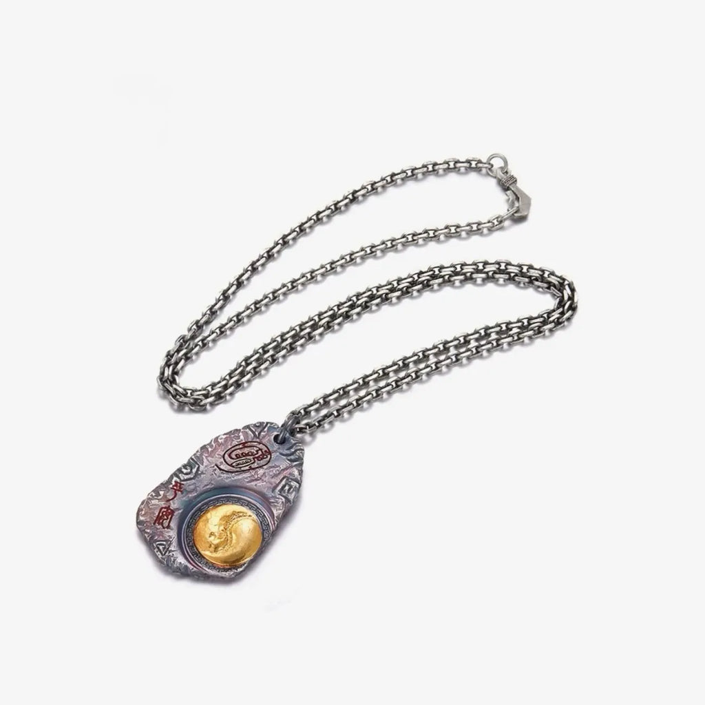 Full shot of the Taichi necklace with a silver chain, displaying the pendant's connection and length