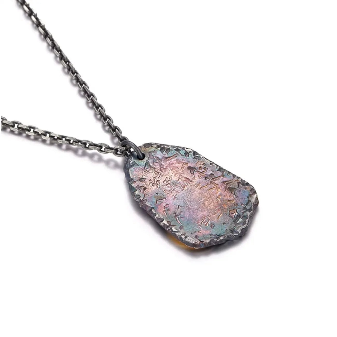 Back view of the Taichi necklace pendant, showing the hammered uneven texture and metallic sheen
