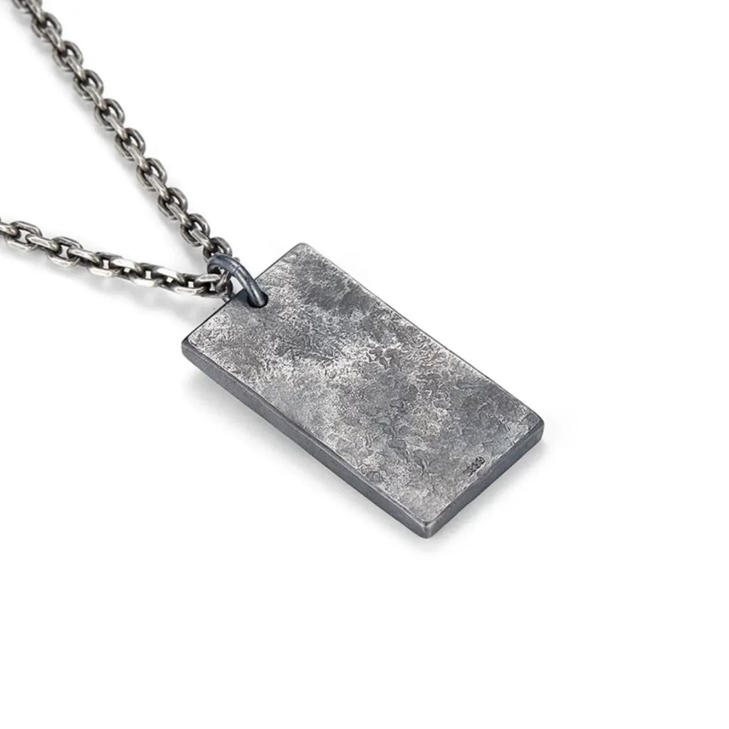 Back view of the Fortune Key necklace pendant featuring a rugged, oxidized silver texture