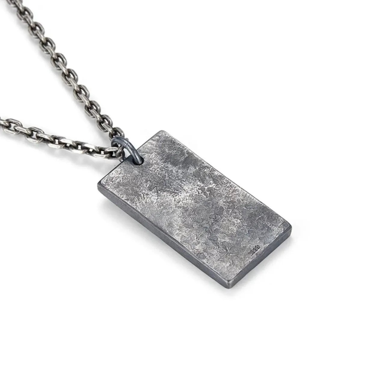Back view of the Fortune Key necklace pendant featuring a rugged, oxidized silver texture