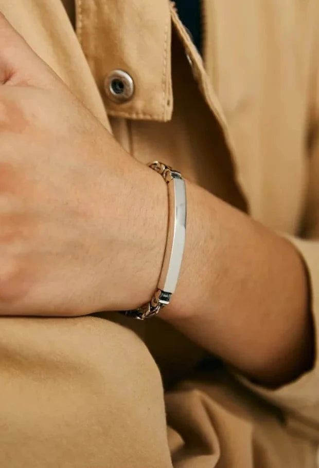 Close-up showing the bracelet's ergonomic fit and the high-polish finish that reflects the surroundings
