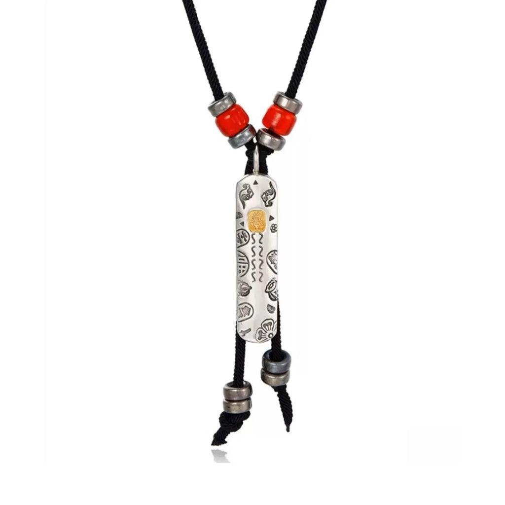 Front view of the Tibetan guardian charm necklace featuring a silver tag with auspicious cloud patterns and a gold center accent