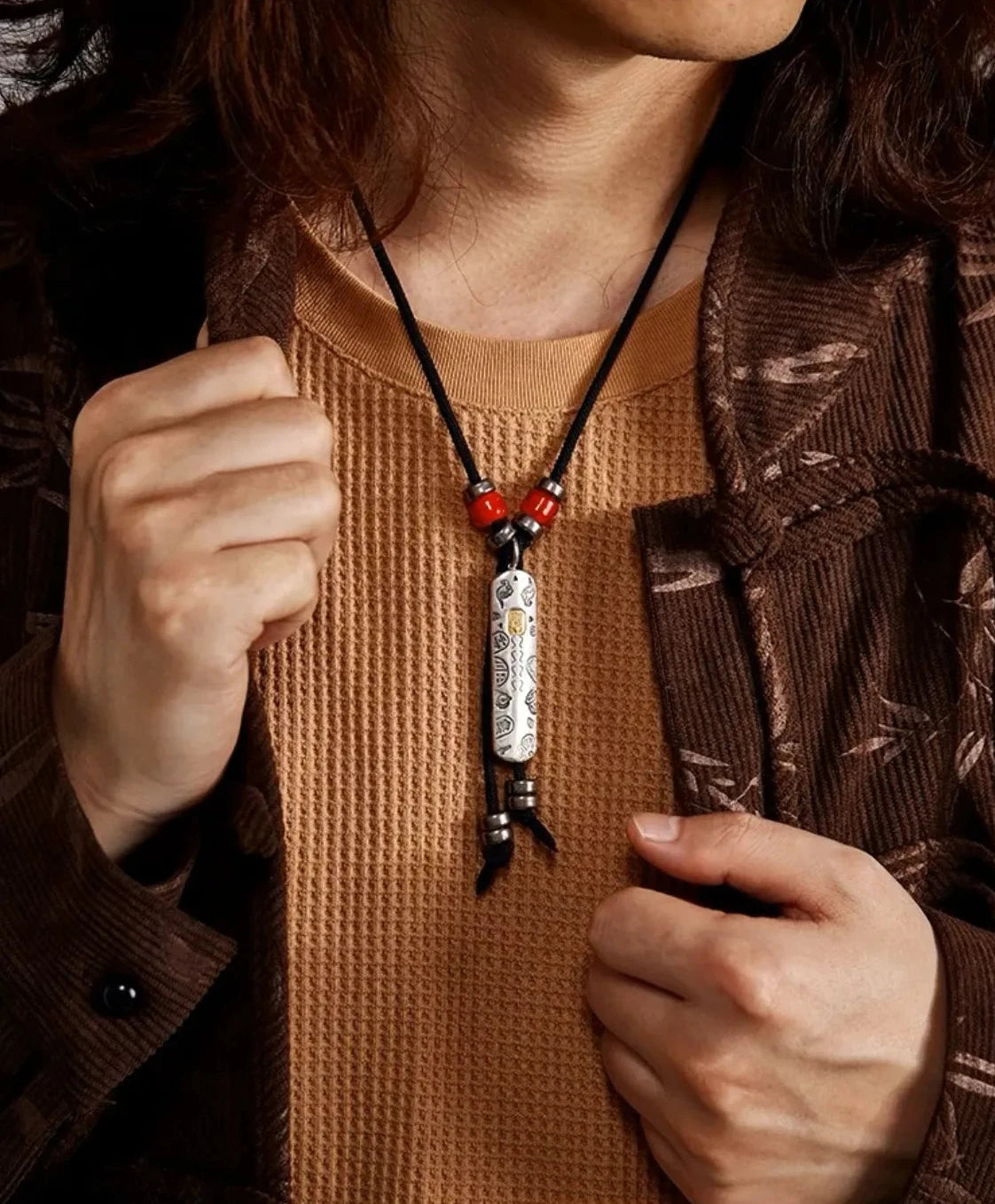 Model wearing the Tibetan guardian necklace with a brown textured shirt, displaying the pendant's drop length