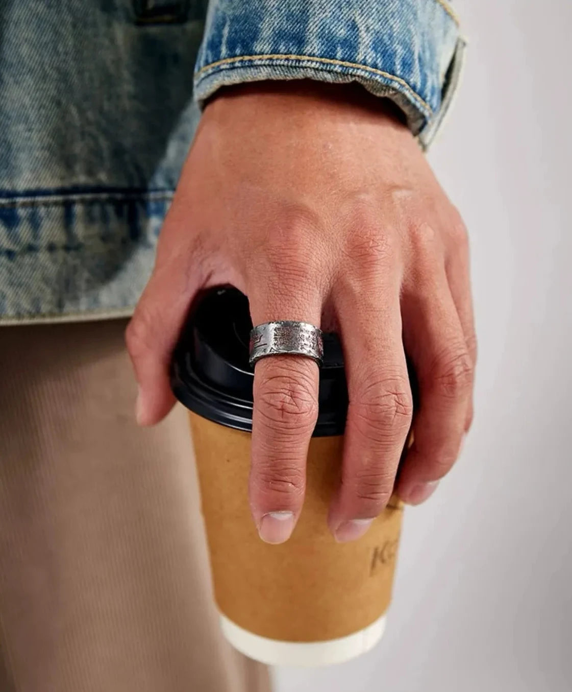 Close-up wearing effect of the silver Taoism amulet ring, highlighting the vermilion contrast against the skin