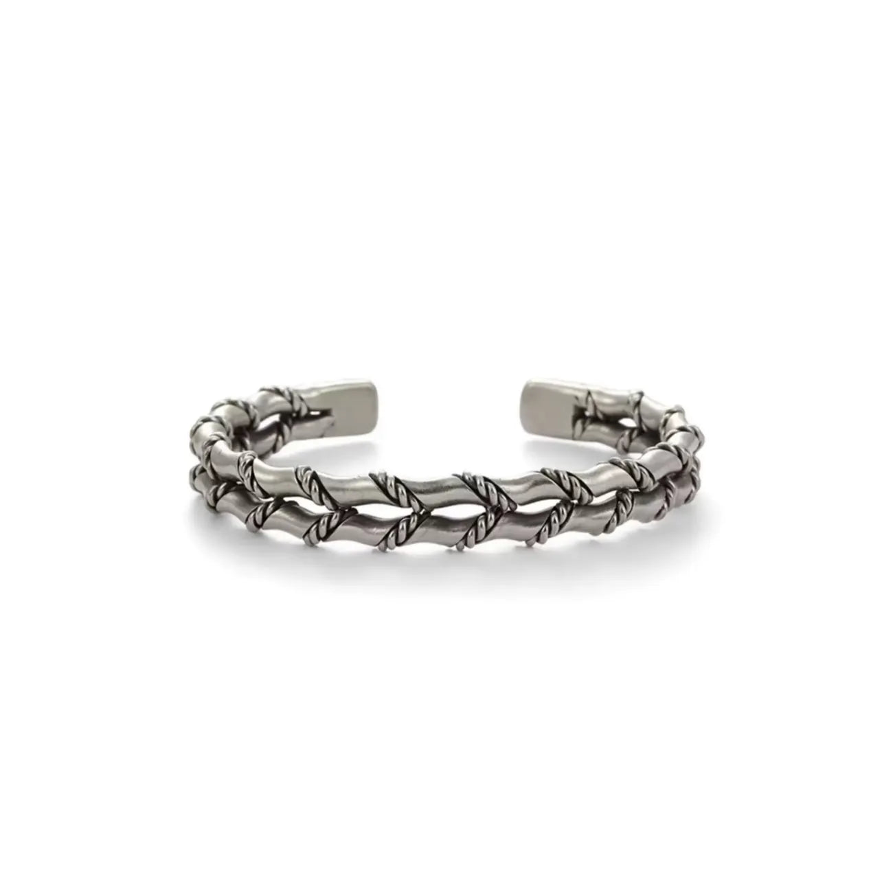 Front flat lay of the bamboo-style cuff, showing the symmetrical braided structure and the contrast between polished highs and darkened lows