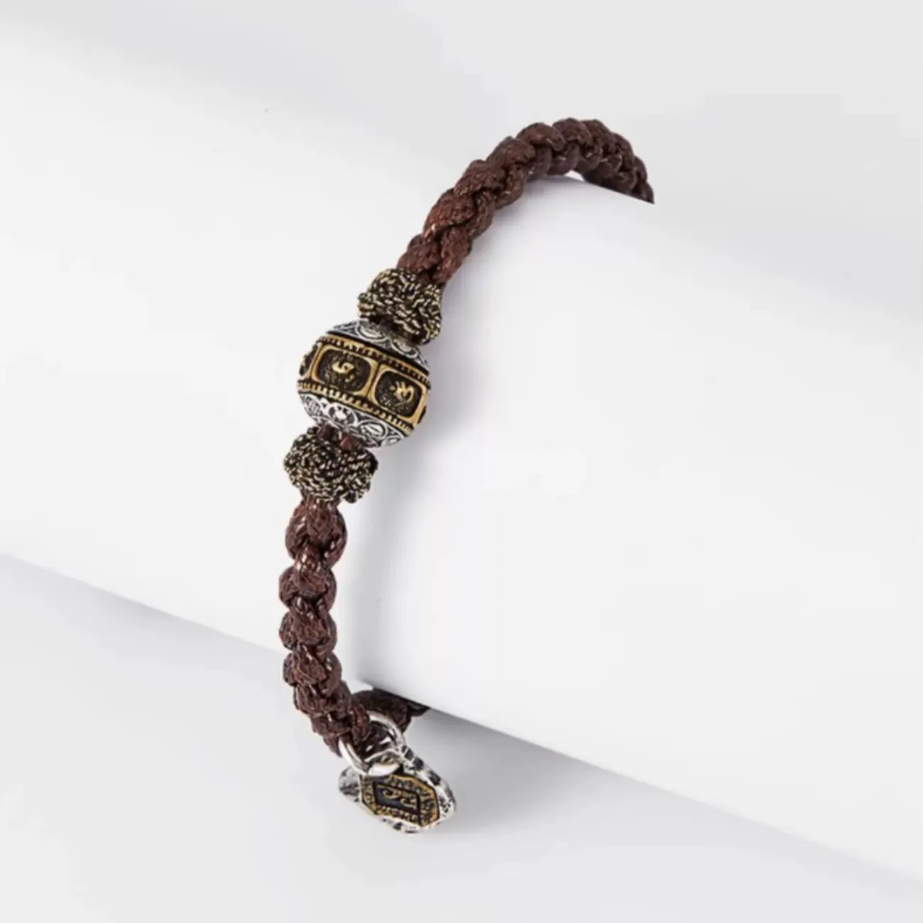 Top-down view highlighting the craftsmanship of the metal spacers and the rugged texture of the brown cord