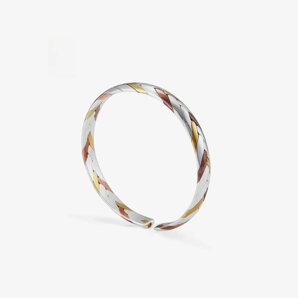 Top angle displaying the continuous braid pattern, highlighting the contrast between the cool silver and warm gold/red tones