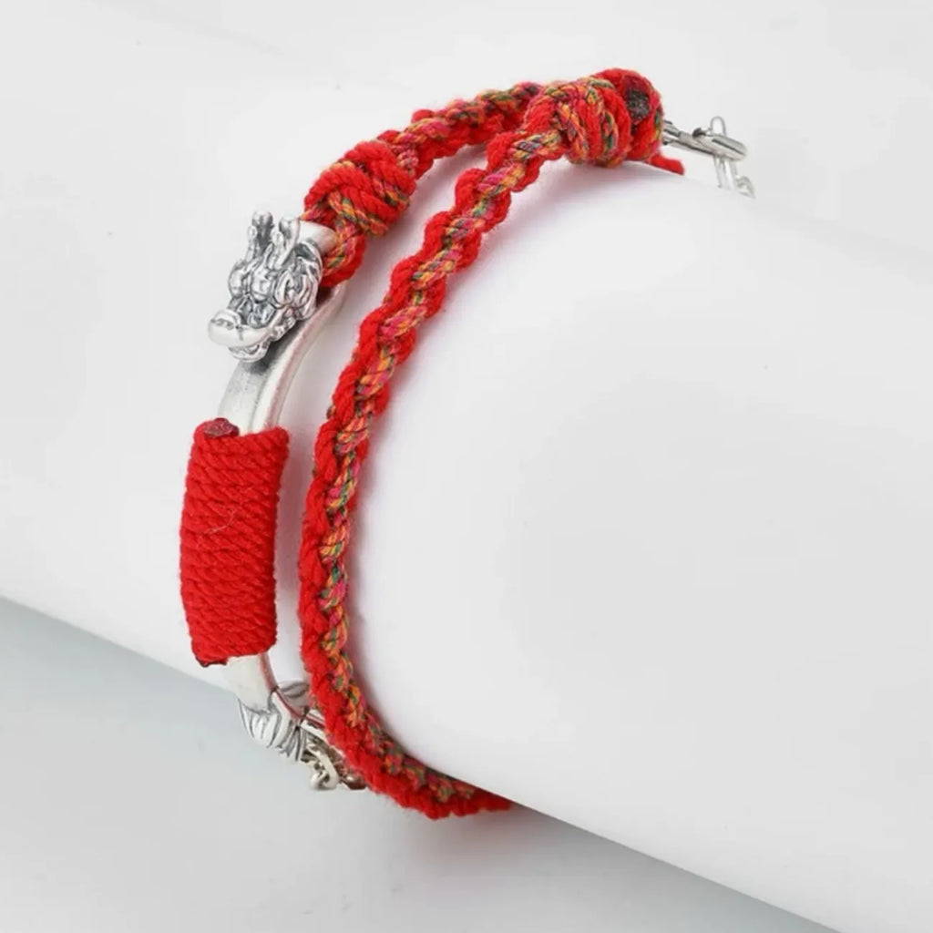 Side profile showing the intricate silver serpent/dragon head clasp and the double-layer structure