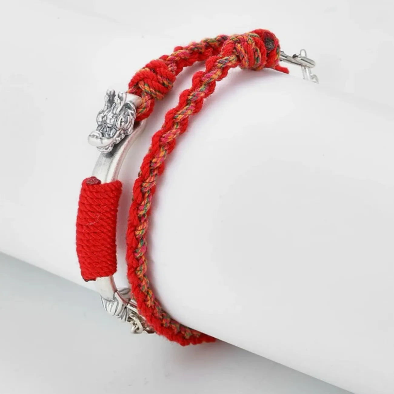 Side profile showing the intricate silver serpent/dragon head clasp and the double-layer structure