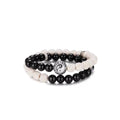 Front view of the black obsidian and white lava stone bracelet set featuring a central silver Yin Yang charm