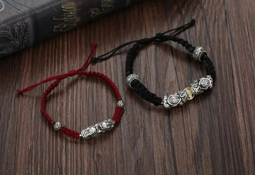 Side detail showing the intricate "Fu" (Blessing) character carved on the silver Pixiu and the gold coin accent for wealth attraction