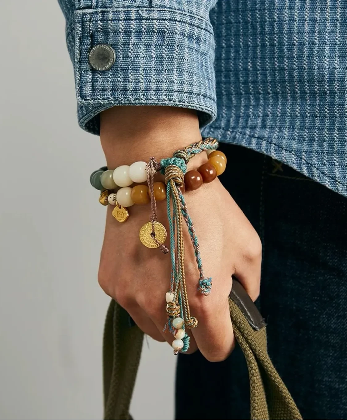 Artistic shot of clasped hands wearing the Taoist bracelet, evoking a sense of peace, balance, and mindfulness